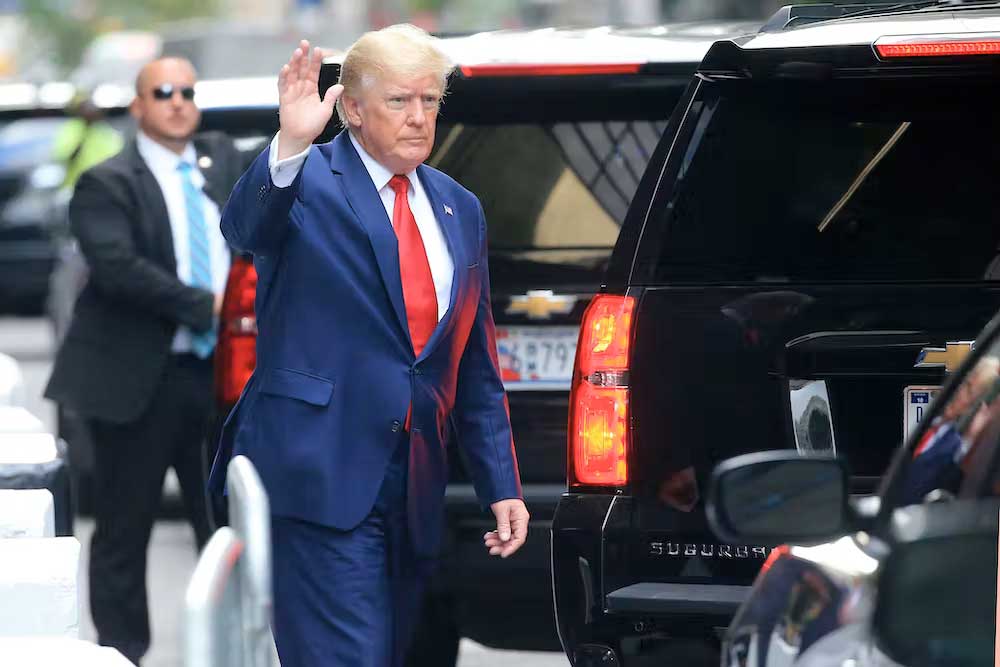 Donald Trump waves while walking to his car in New York City on Aug. 10, 2022. Stringer/AFP via Getty Images